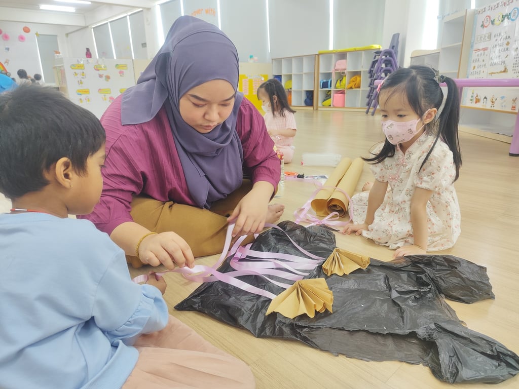 Teacher guides students in a festive craft project for Cherie Hearts’ Chinese New Year celebration.