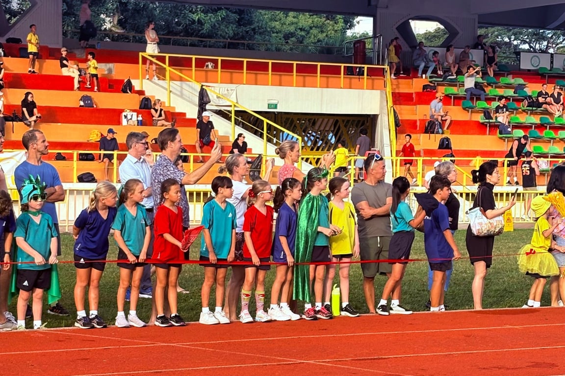 Students and parents watch on from the sidelines during the Athletics Carnival event