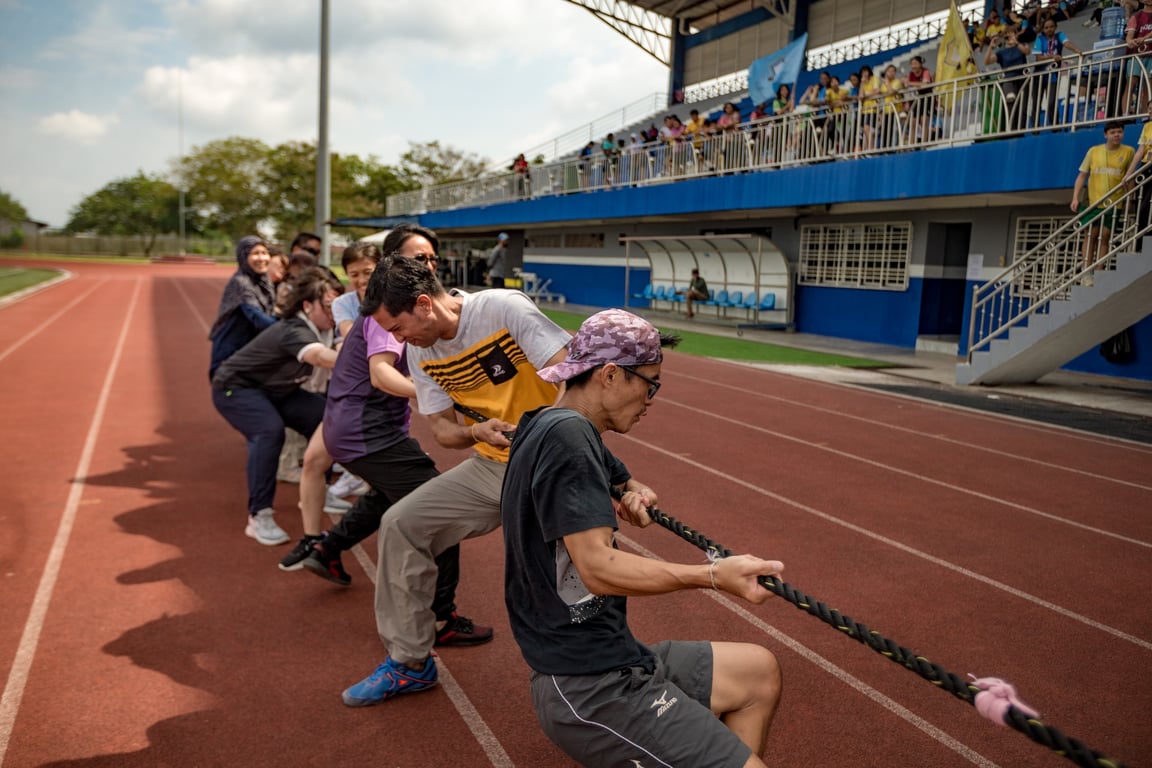 Teachers and Parents competing against each other in a friendly sports competition.