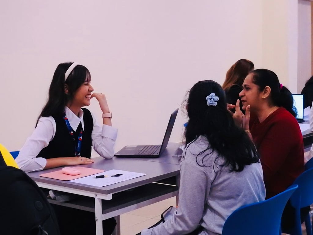 Teacher and parent in discussion during MISKL Parent-Teacher Conference.