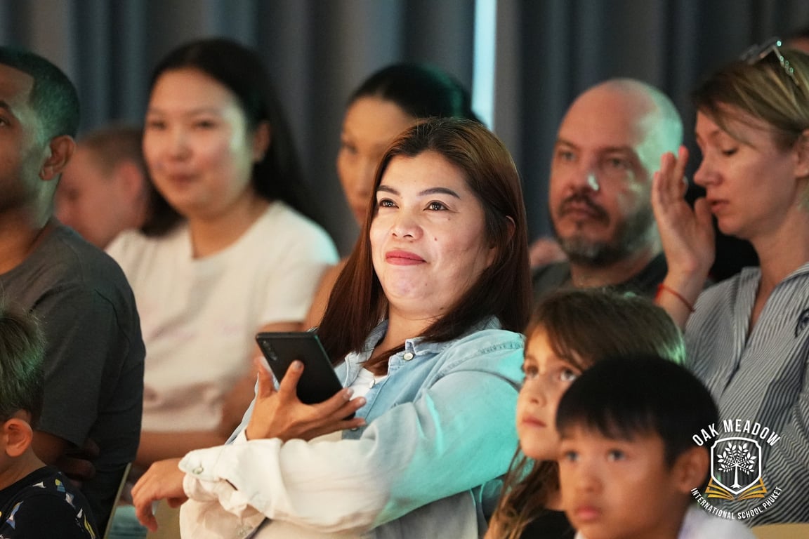 Parents and children watching student performances at Oak Meadow’s school production.