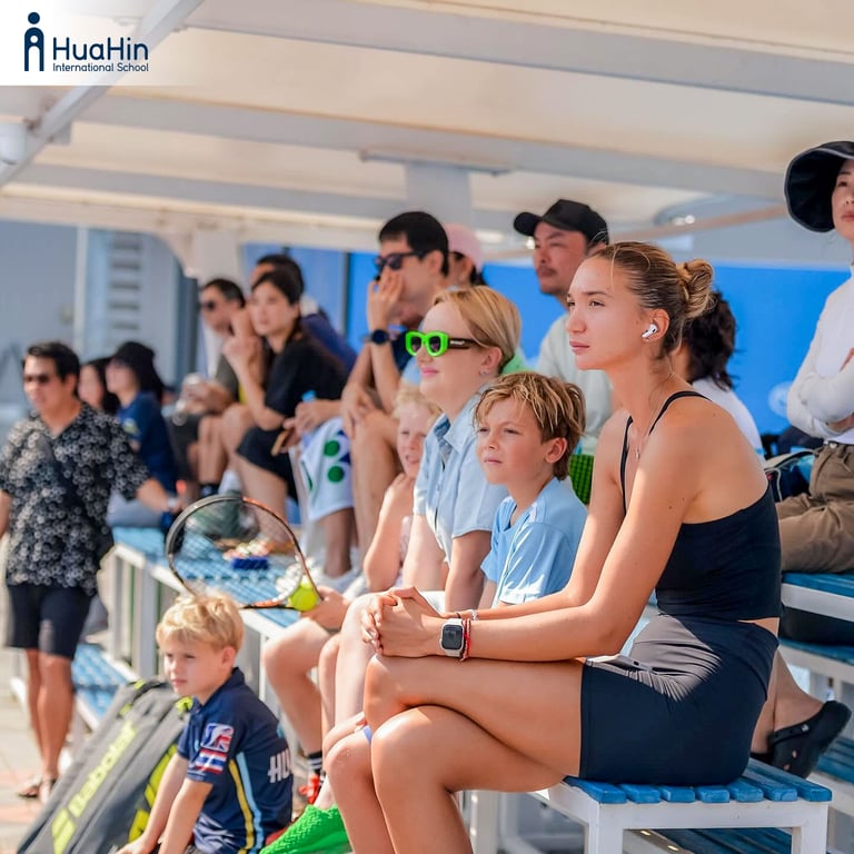 Families watching the FOBISIA tennis tournament.