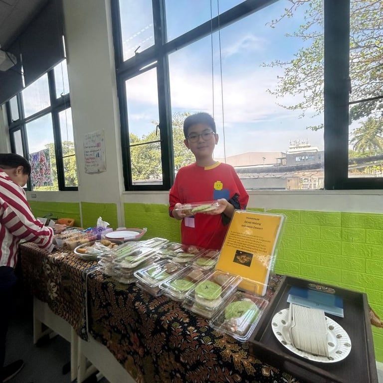 A student mans a food stall during International Day, a vibrant showcase of the different cultures in the student body.