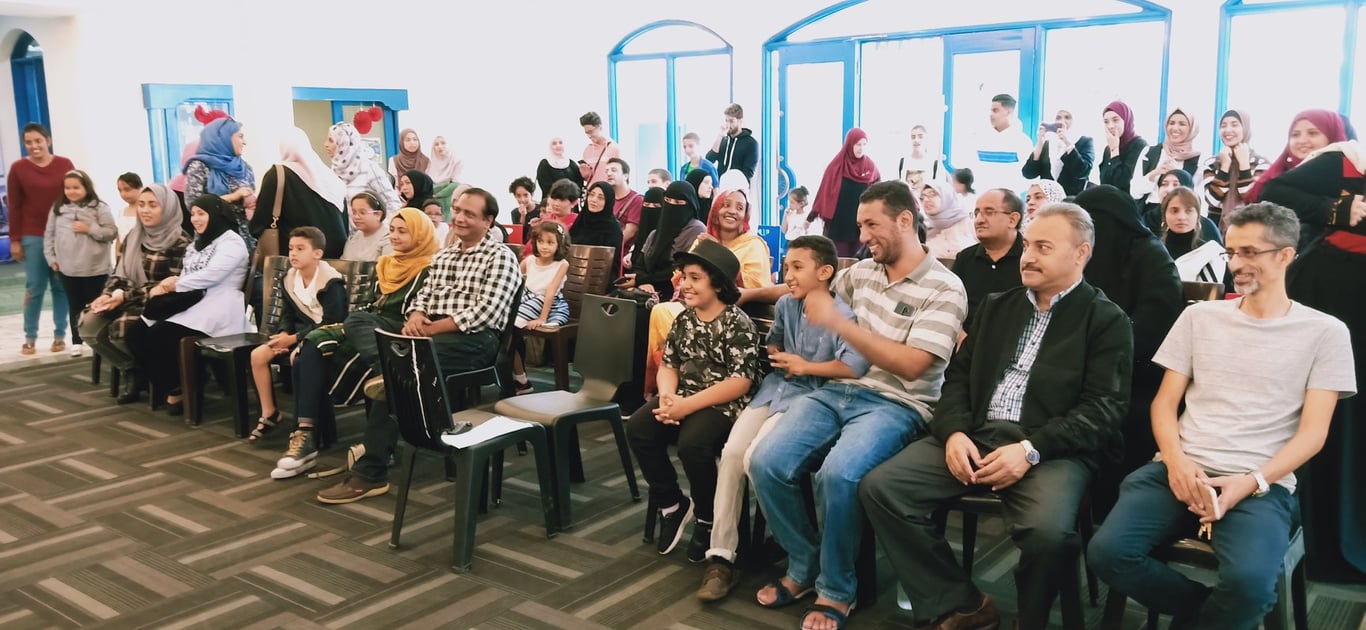 Parents join the classroom to watch the student's presentations.