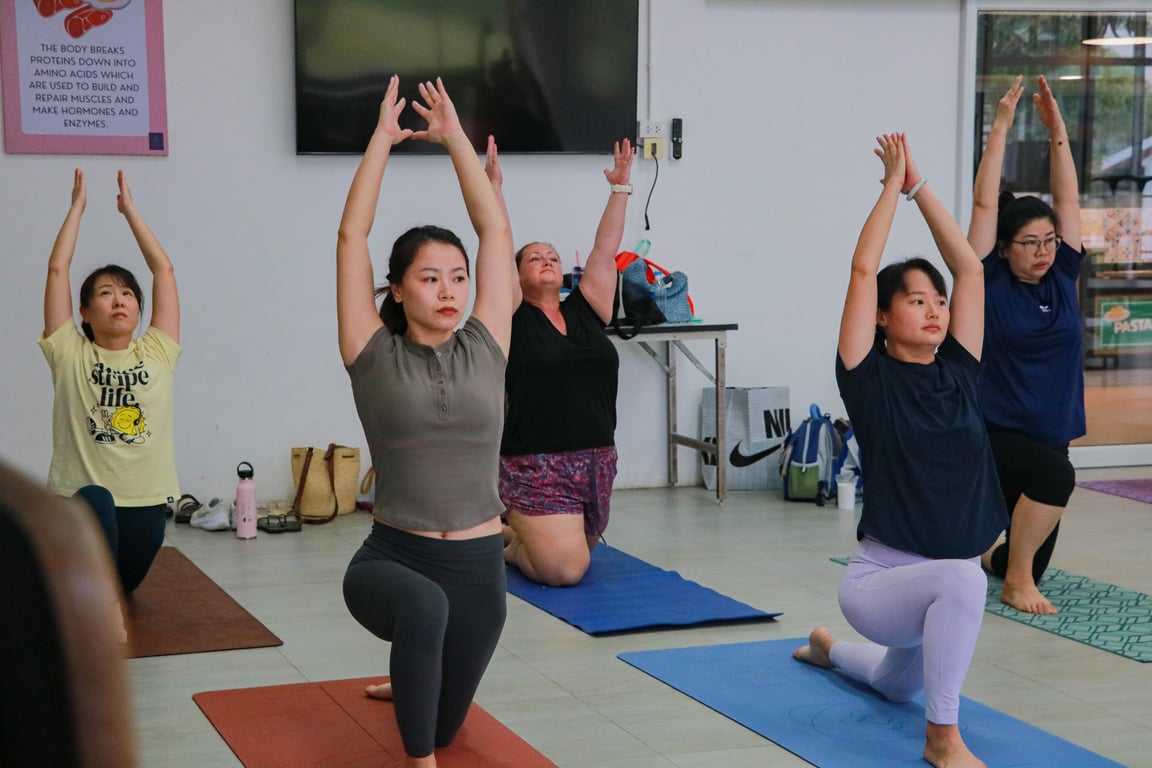 Parents participating in a relaxing yoga class organized by the school.