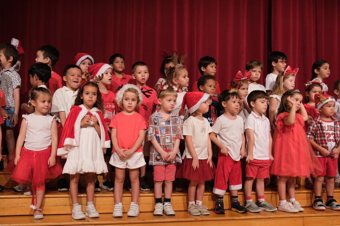 IFS Students deliver a performance for the Christmas show, on stage in front of parents and other students