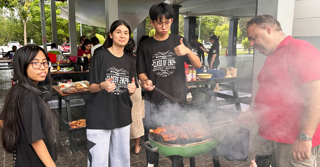 Year 11 students grilling food during the camp barbecue night.