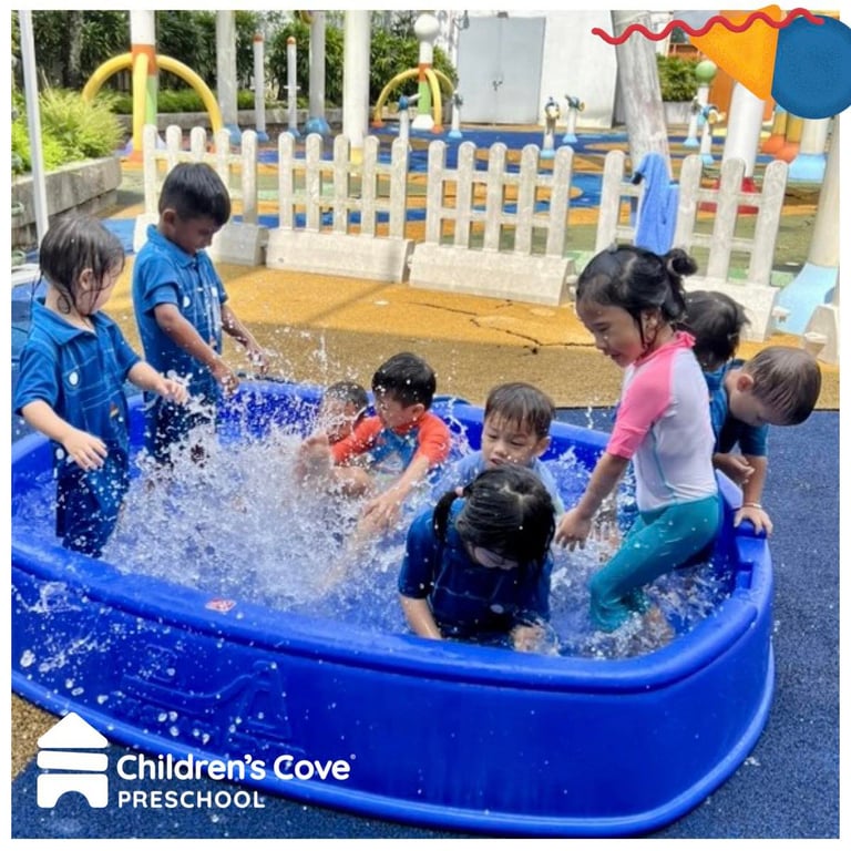 Children engaging in water play, an activity for motor and social skills.