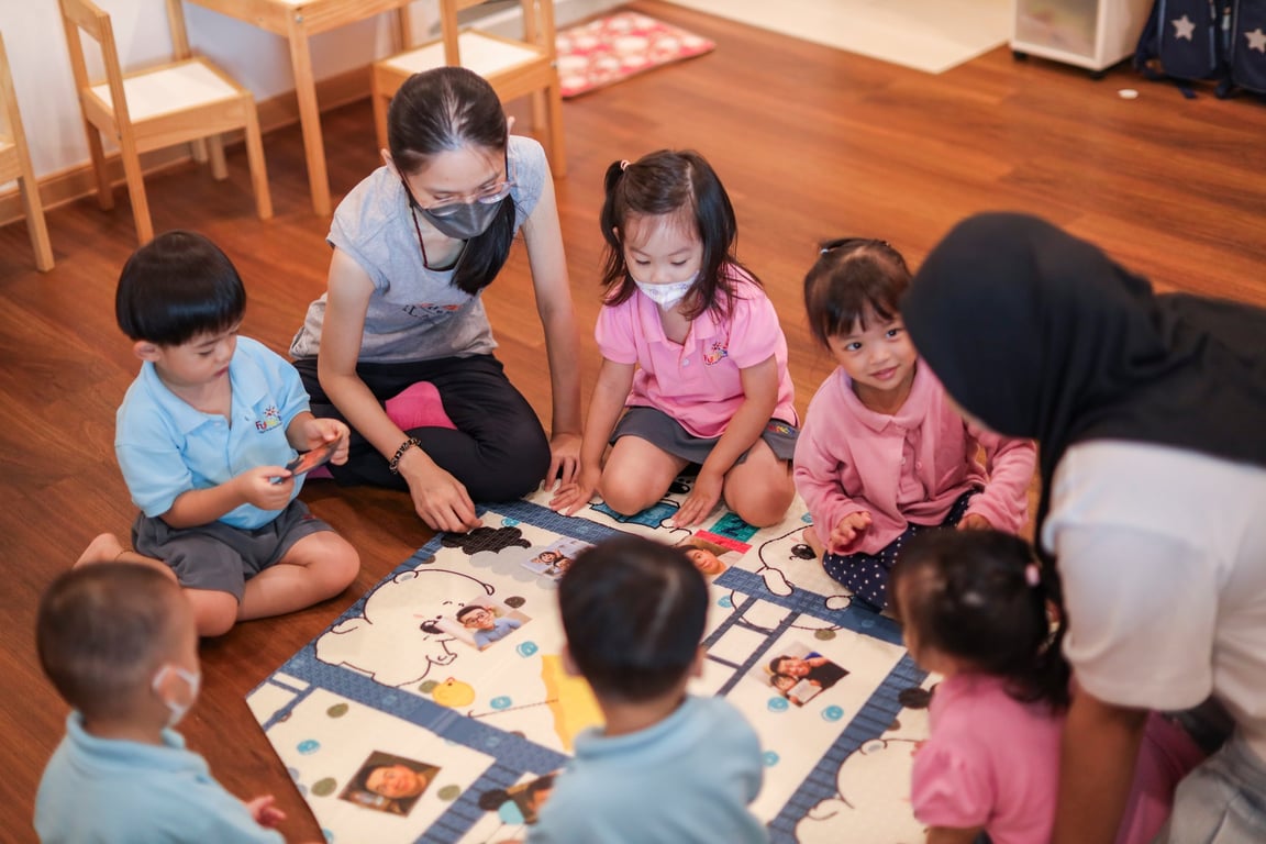 Students being guided by teachers during a class activity.