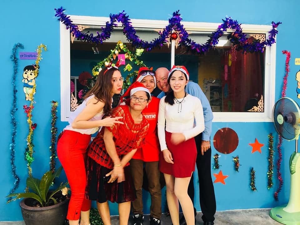 Teachers and staff dressed up for a festive holiday celebration.