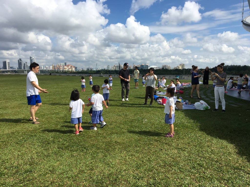 Families enjoying the Parents Day school event, which involved a park picnic