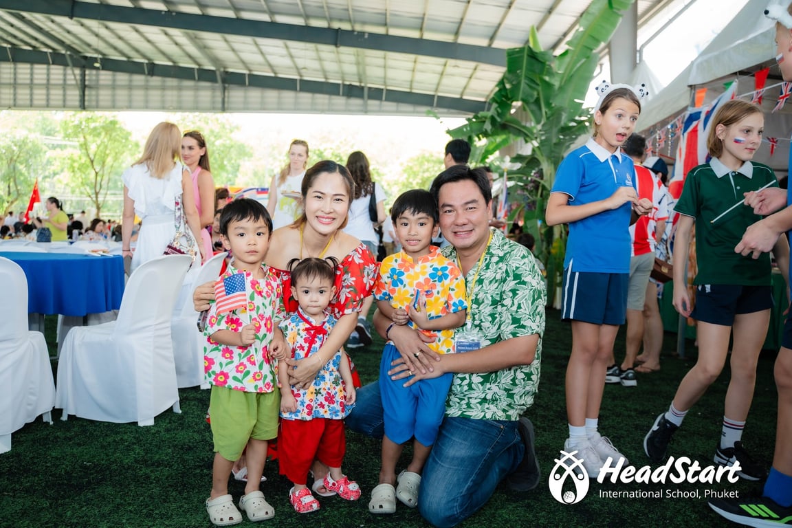 Family posing together during International Day celebration at Cherngtalay campus.