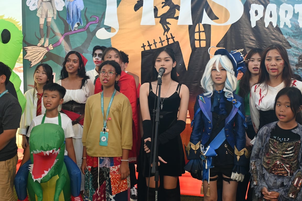 Dressed in creative and spooky costumes, students take the stage for a lively Halloween performance.