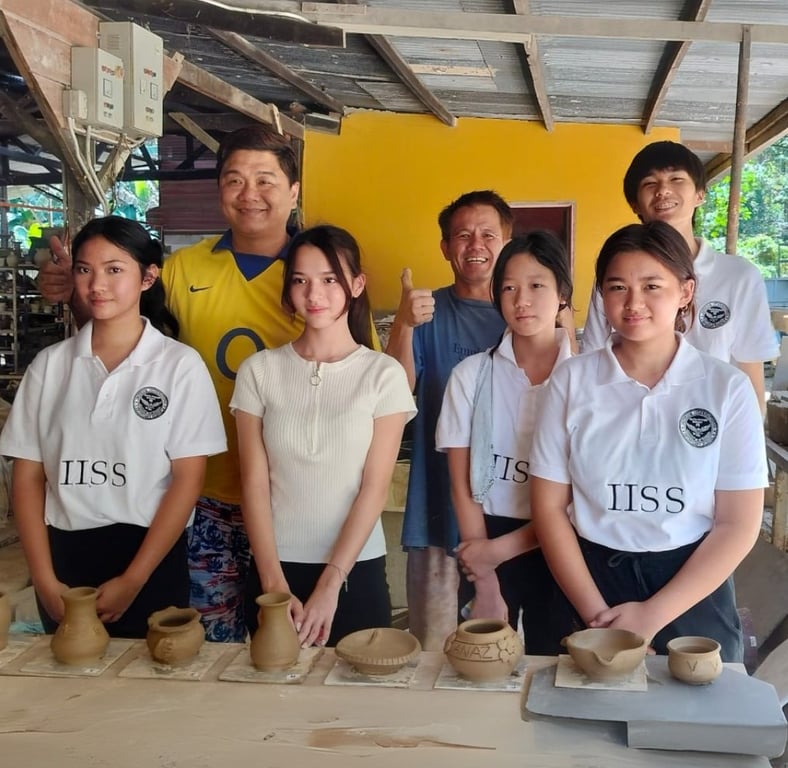 Students display their handcrafted clay creations following a hands-on pottery workshop led by local artisans.
