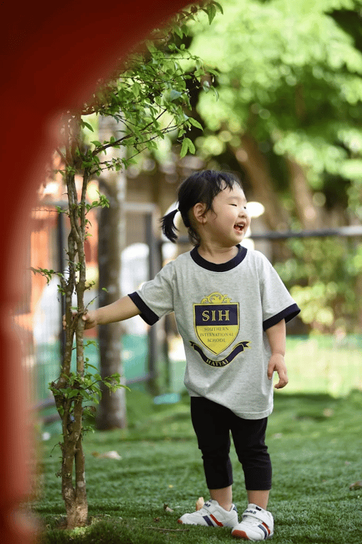 Child enjoying nature in the school’s outdoor space.