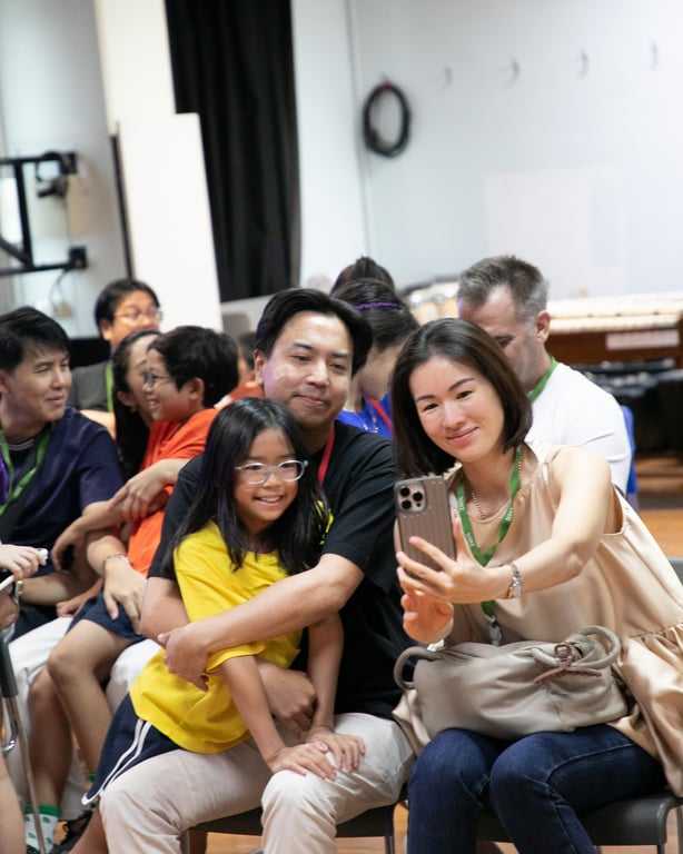 Parents and families attending a music performance by Year 4 students at NIST Bangkok.