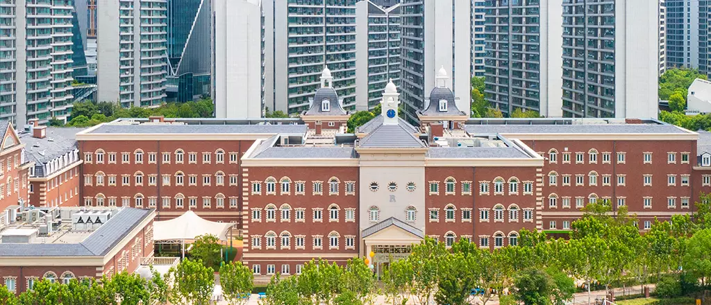 Traditional architecture and expansive grounds at the Wellington International school campus.