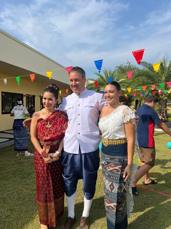 Staff dressed in traditional Thai attire during Loy Krathong event.
