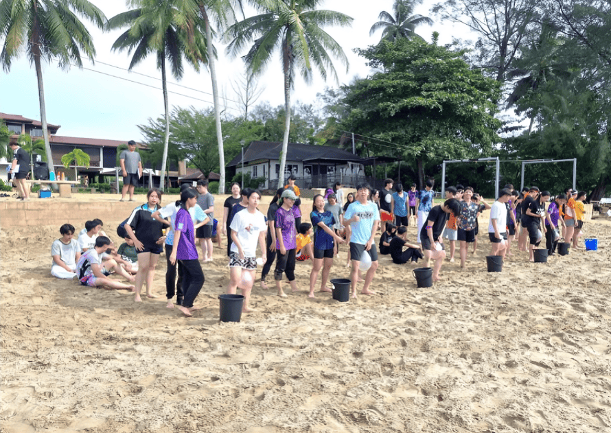 Teamwork and resilience built through hands-on beach challenges during outdoor learning camp.