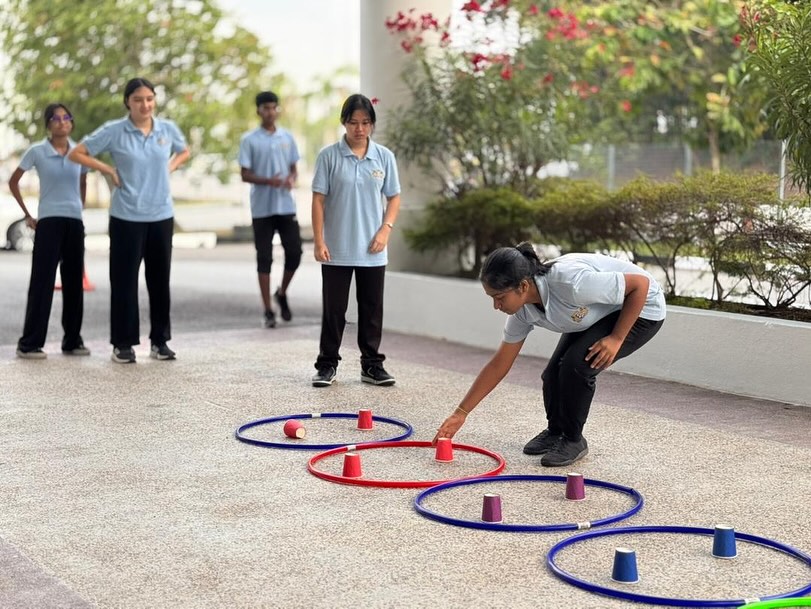 Students strengthening coordination through fun group challenges.