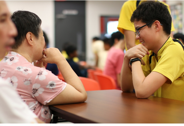 student engages warmly with a community member, reflecting the school’s commitment to empathy and meaningful connection