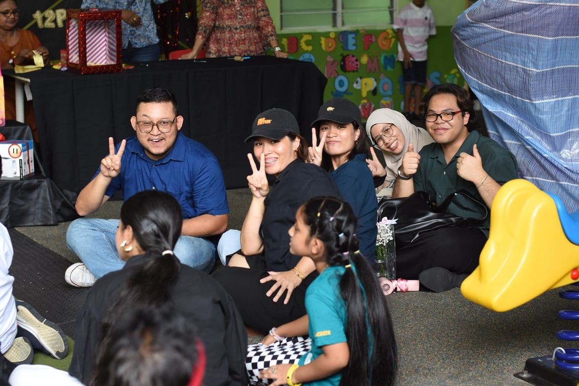 Teachers and students sharing smiles during the school carnival celebration.