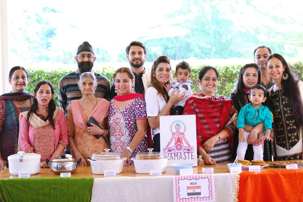 ISC families presenting traditional Indian dishes and attire.