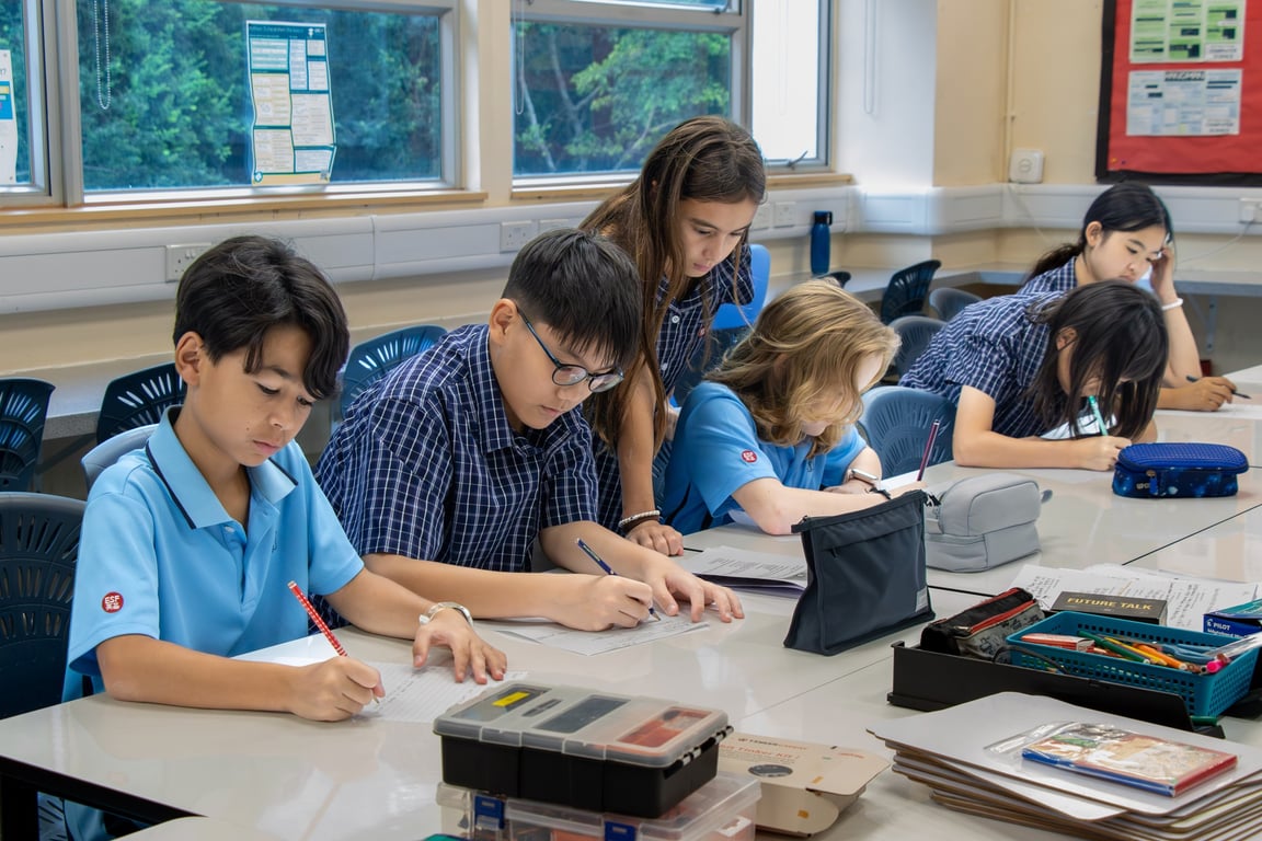Students working on written assignments during a classroom activity.