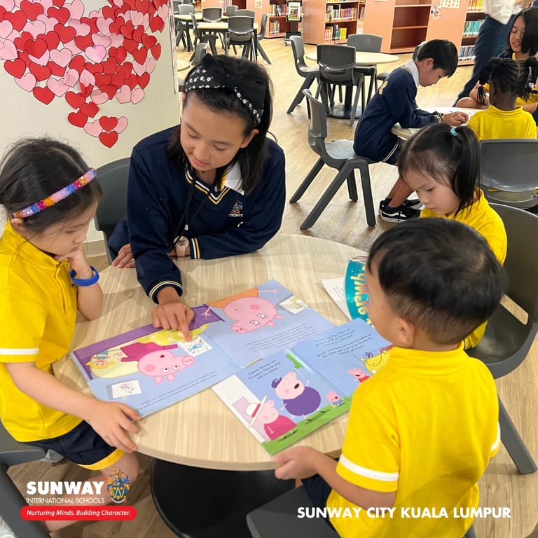 Grade 5 students taking on leadership roles by being reading buddies to the junior Kindergarten students.