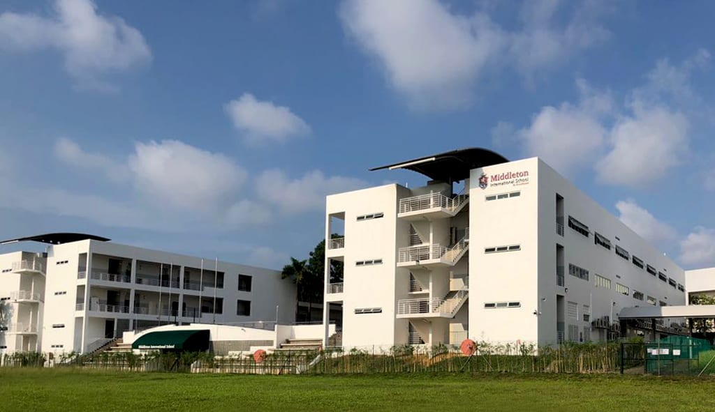 A front view of the Middleton campus, showing the sports pitch and school buildings
