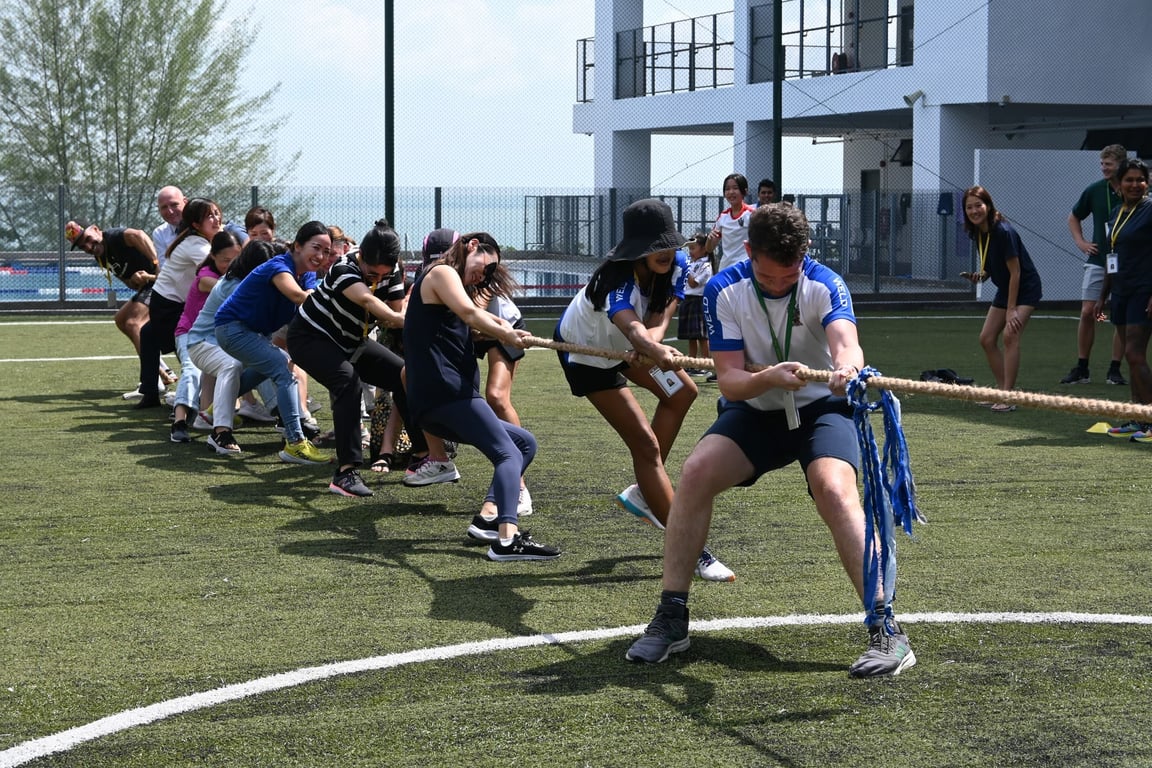 Parents participating in tug-of-war.