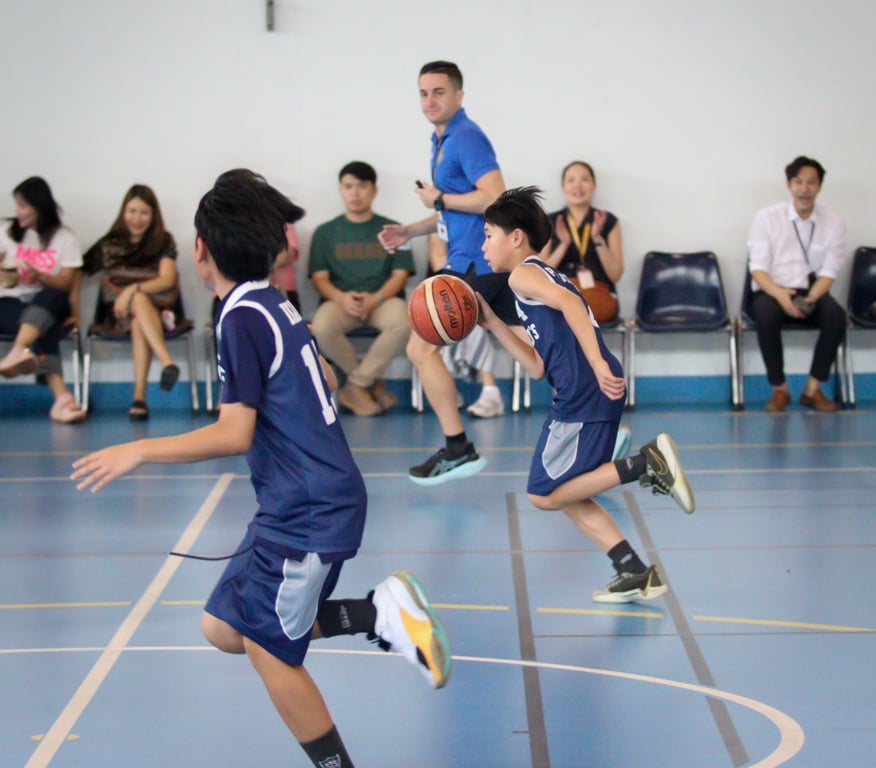 U11 boys basketball team competing in a TISAC league match.