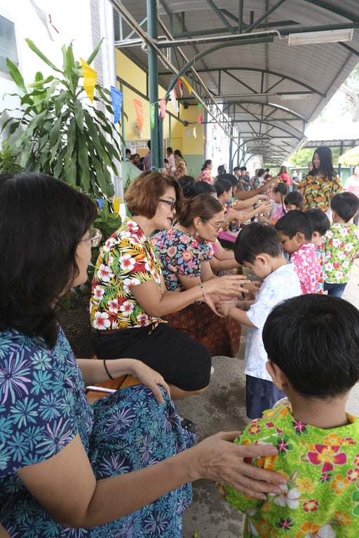 Parents, teachers, and children at the Songkran celebrations.