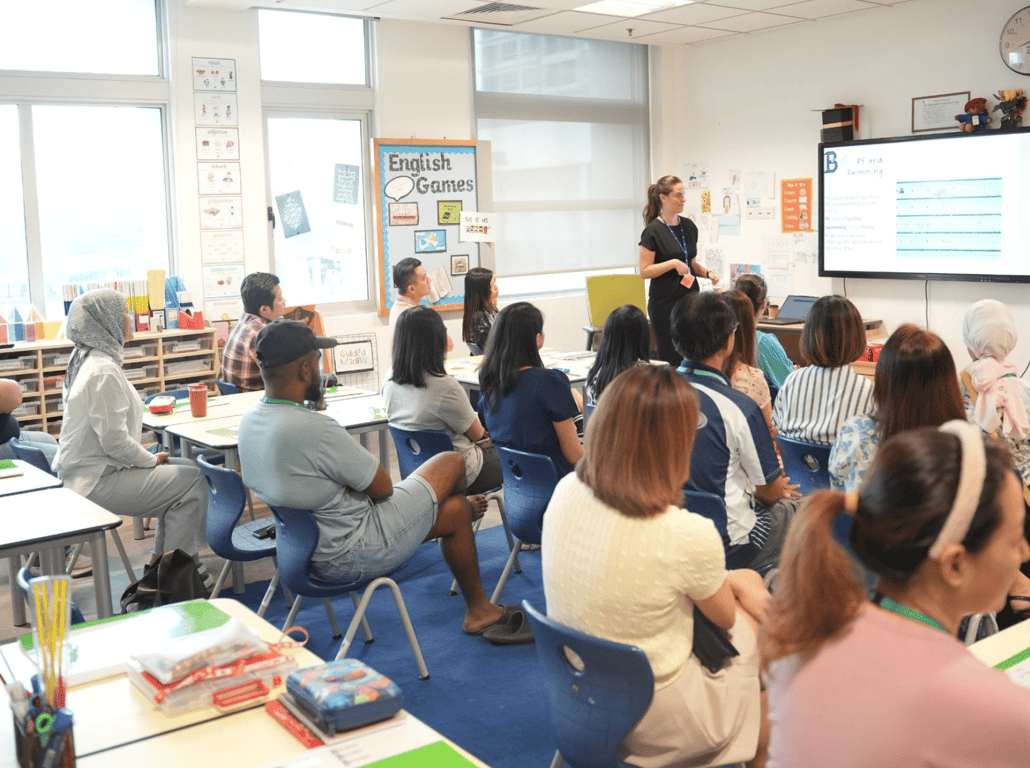 Parents connecting with their child’s homeroom teacher in a 