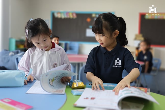 Students reading and working together during a classroom activity.