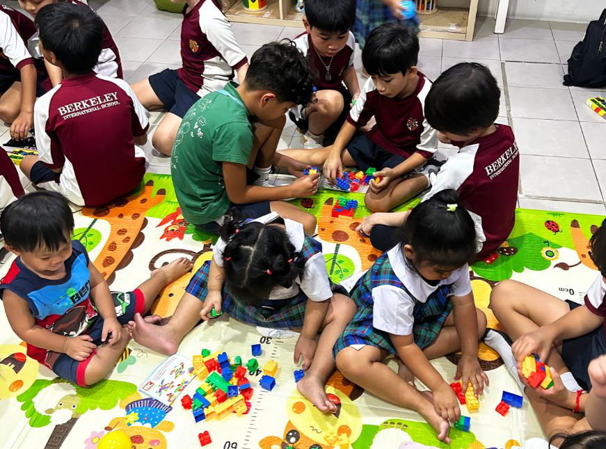 Students from different age groups engage in shared playtime activities.