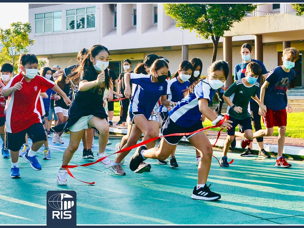Students crossing the finish line during a school race.