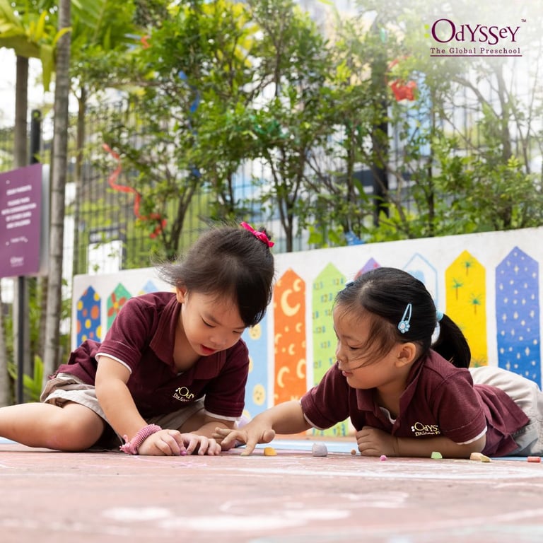 Students coloring in the outside play area.