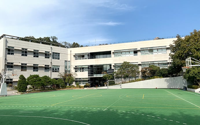 School courtyard and sports facilities at Lycée International Xavier.