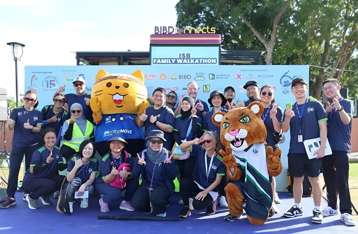 ISB staff and families gather for the ISB Family Walkathon, joined by mascots and event partners at a community event.