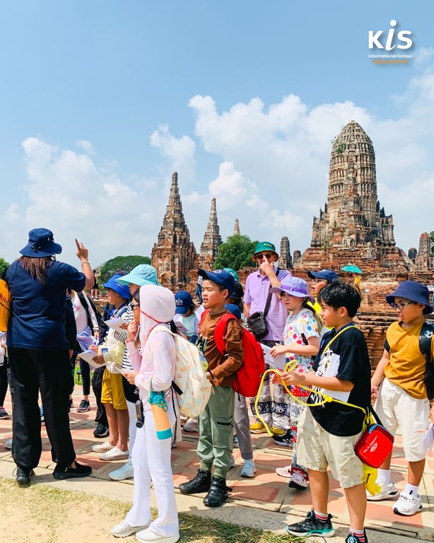 Students visiting historic temple site during school field trip.
