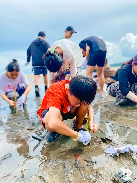 Children working together on a mangrove restoration activity.