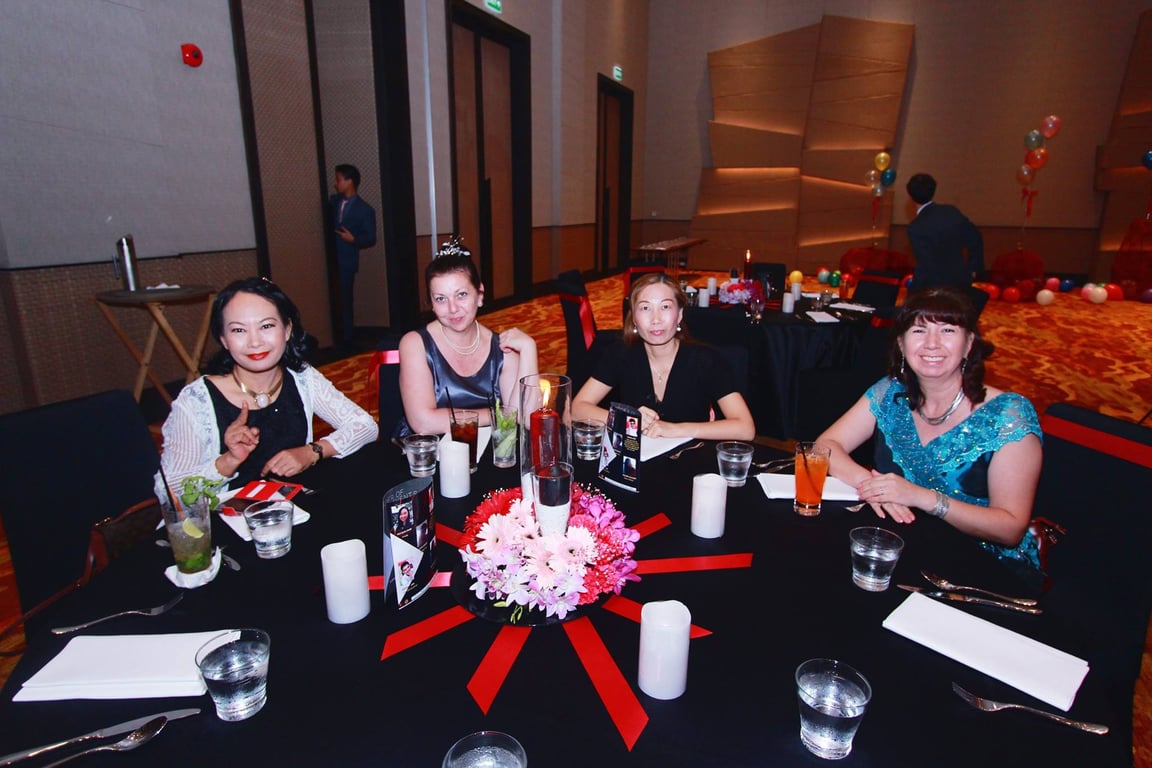 Family members seated at a graduation dinner event.