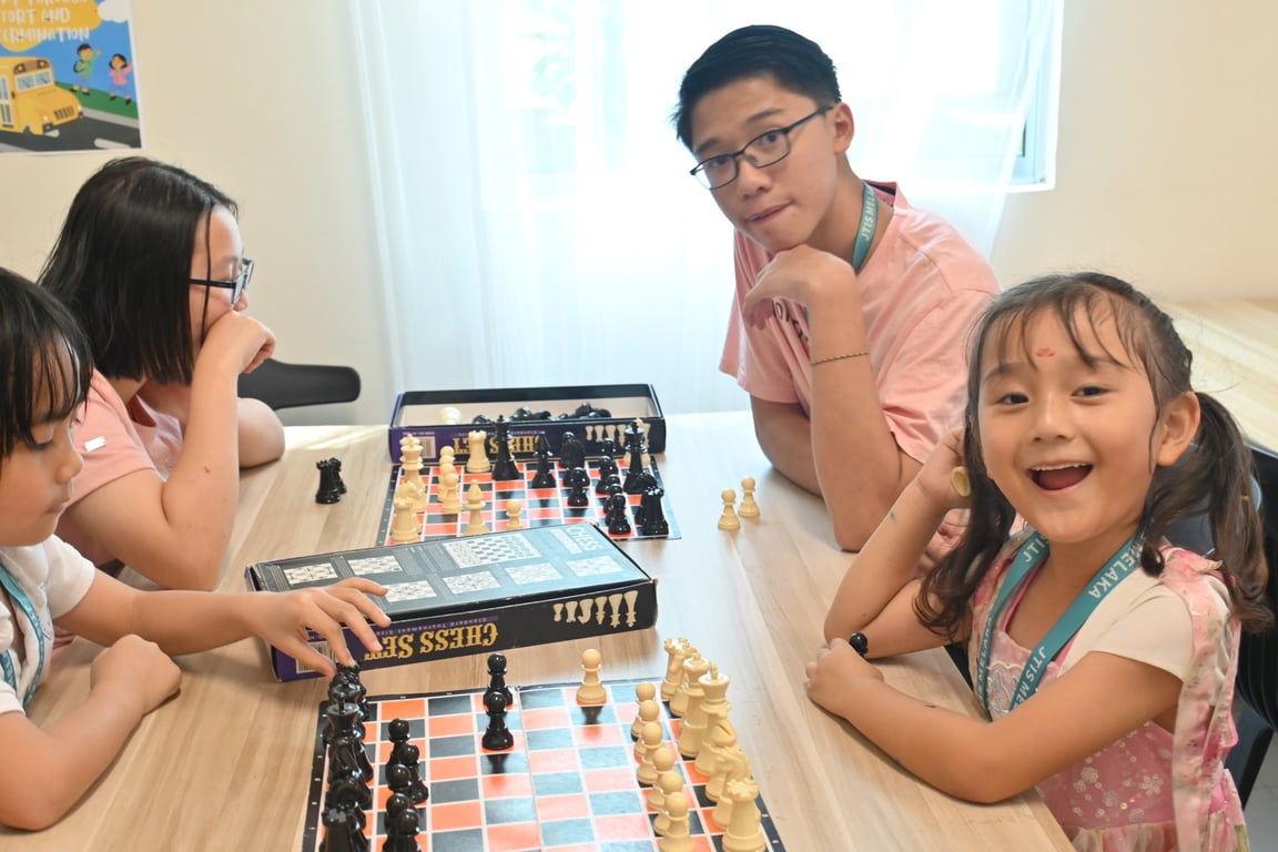Students across age groups enjoy a friendly game of chess, sharpening their critical thinking.