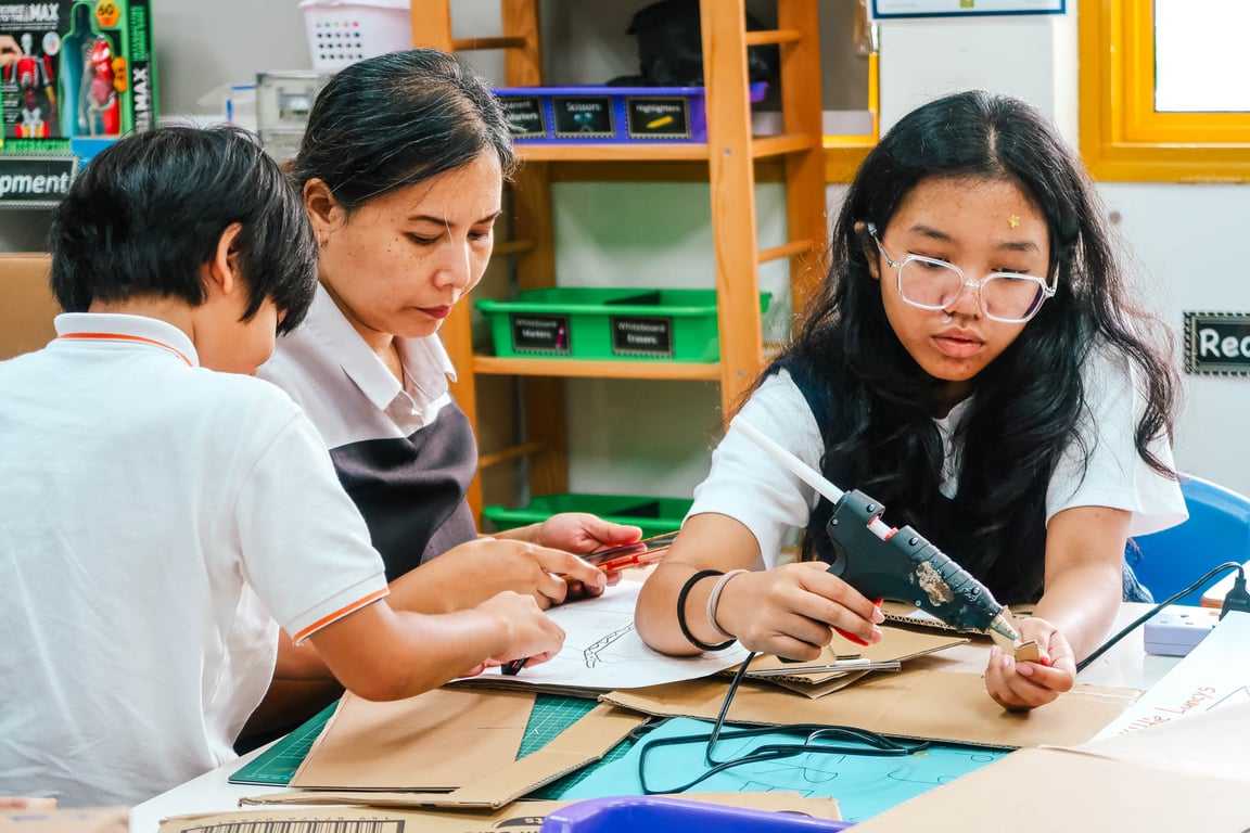 Parents join the class to help students design and craft their own lunchboxes for a product development project