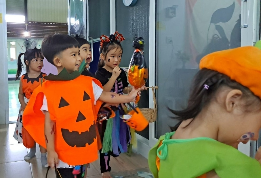 Pumpkin and witch costumes during Halloween 2023 celebration.