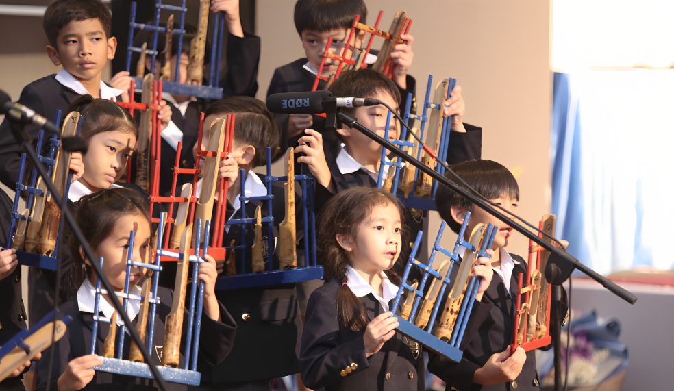 Primary students performing a traditional musical piece in concert.