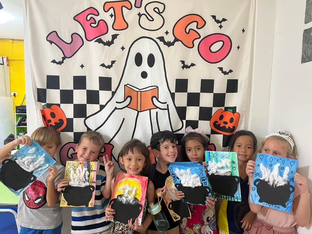 Group photo with handmade cauldron artwork.