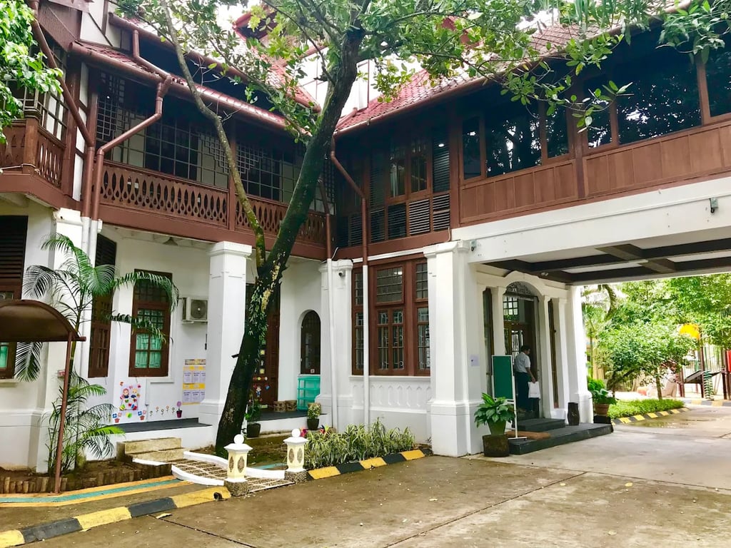 The primary entrance and covered walkway of the Thalun International School campus.