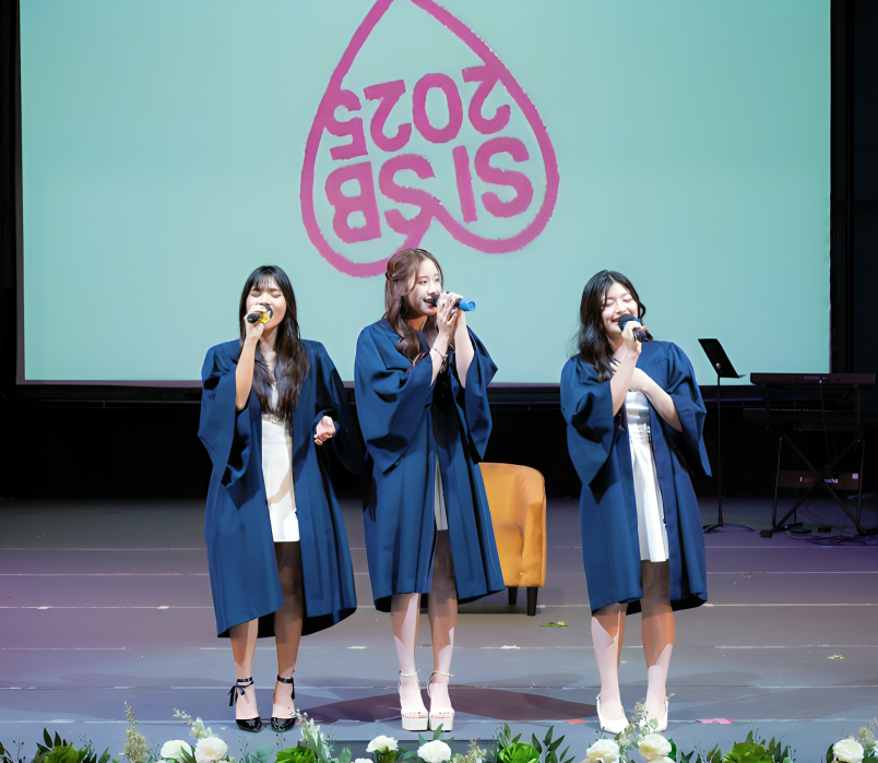 A special moment on stage! Graduates sharing their voices and friendship in a beautiful farewell performance.